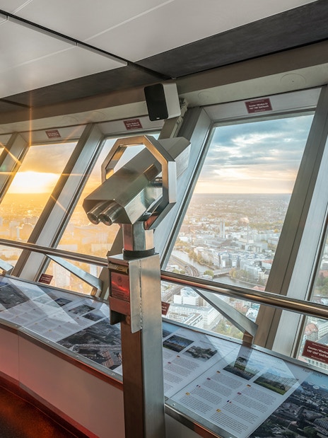 Binoculars on observation deck overlooking Berlin cityscape from TV Tower.