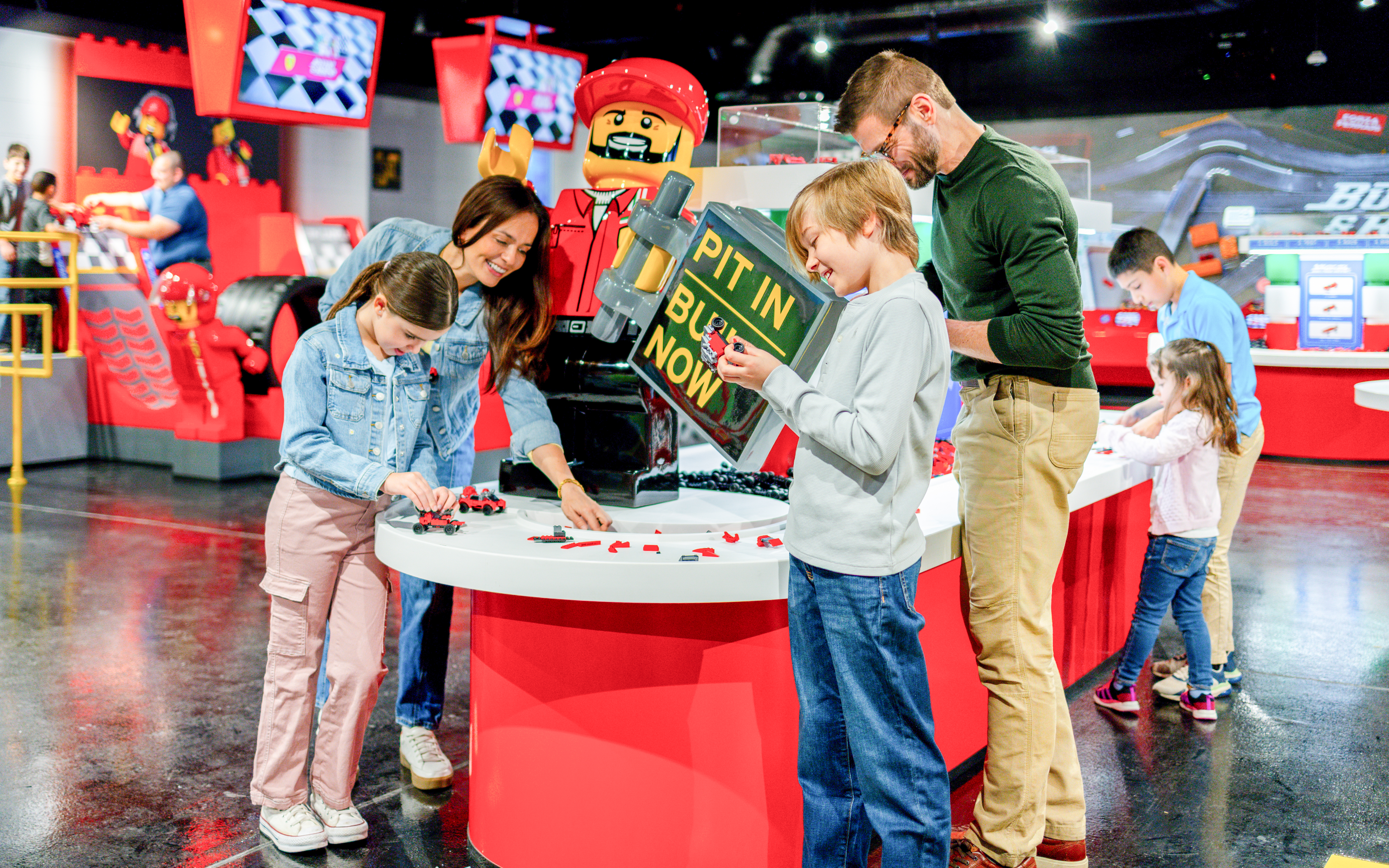 Guests building Lego cars at the Ferrari garage zone, Legoland, New York.