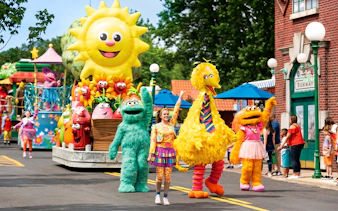 Sesame Place San Diego parade with Big Bird and characters on a colorful float.