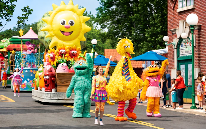 Sesame Place San Diego parade with Big Bird and characters on a colorful float.