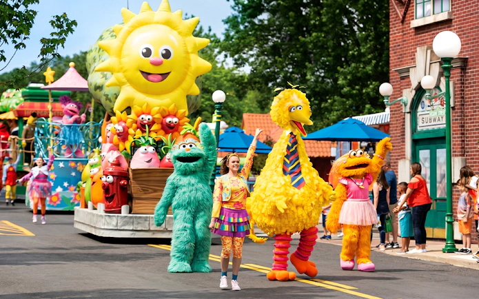 Sesame Place San Diego parade with Big Bird and characters on a colorful float.