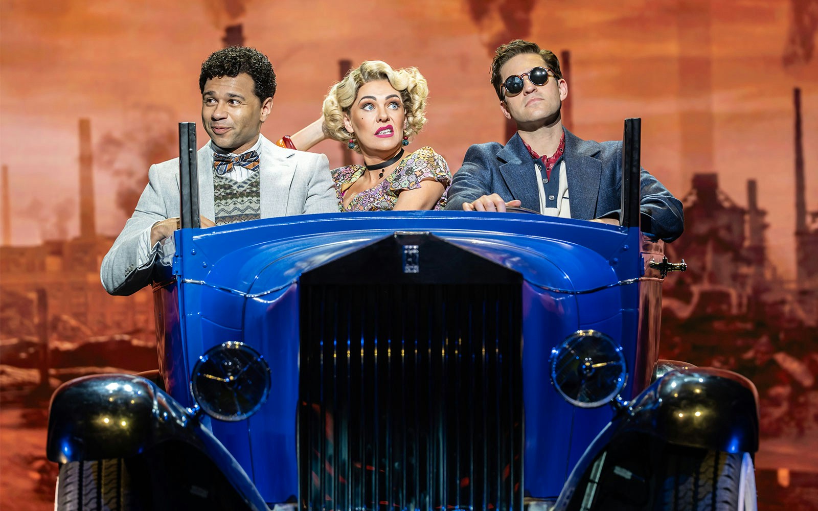 Actors performing The Great Gatsby Musical on stage with 1920s costumes and set design.