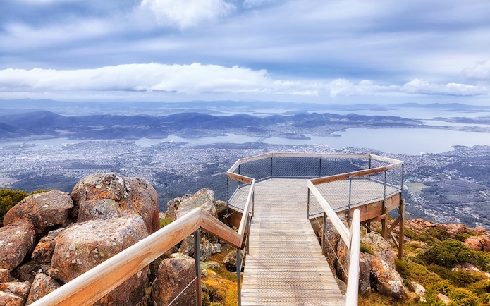 Wooden lookout platform on Mt Wellington overlooking Hobart, Tasmania with expansive city and bay views.