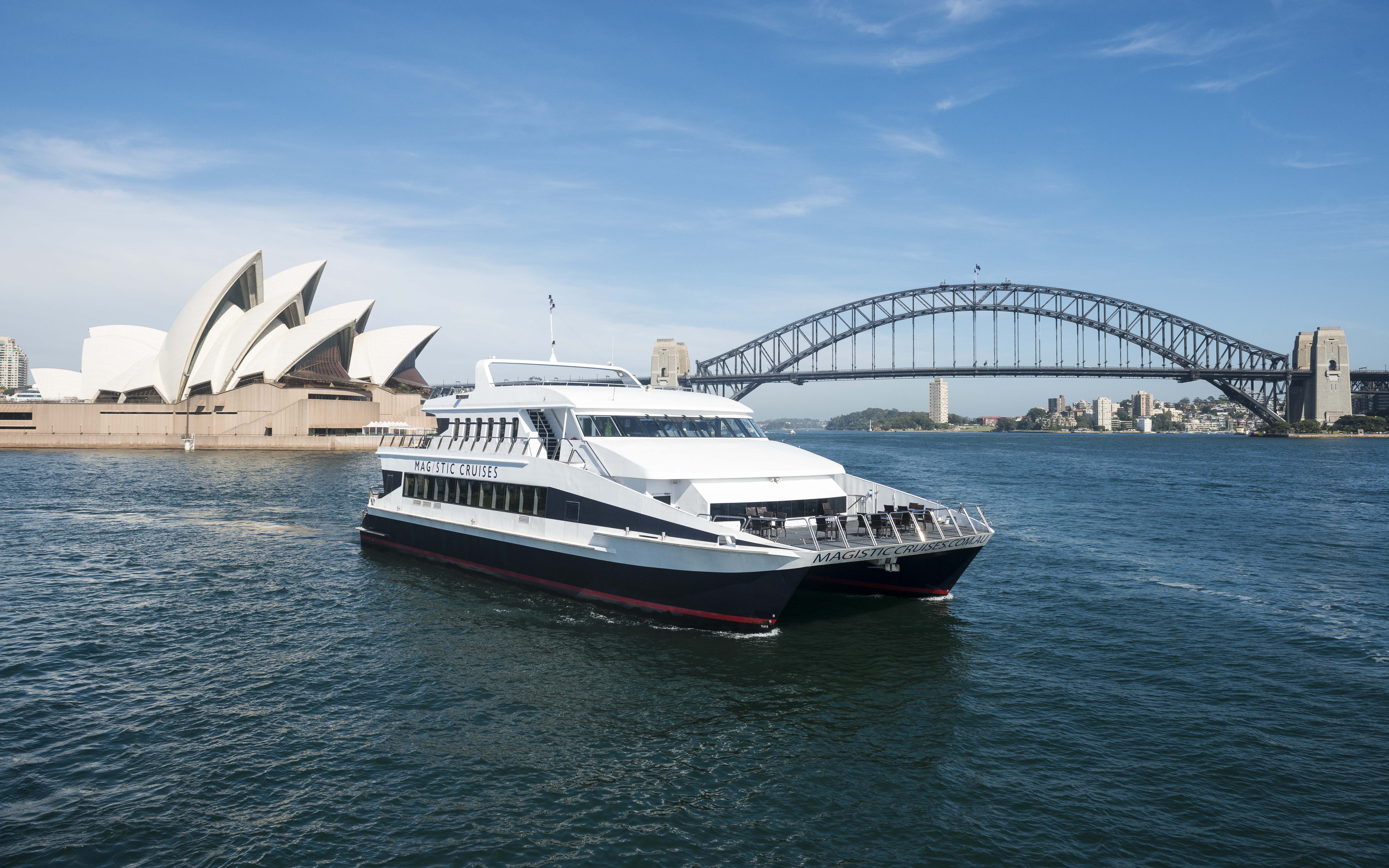 Sydney Harbour cruise boat with Opera House and Harbour Bridge in background.