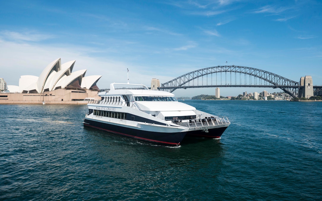 Sydney Harbour cruise boat with Opera House and Harbour Bridge in background.