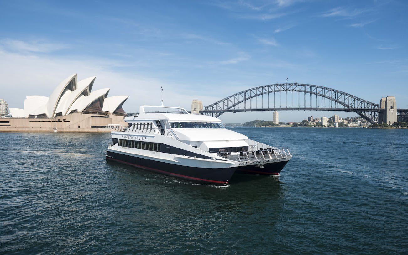 Sydney Harbour cruise boat with Opera House and Harbour Bridge in background.