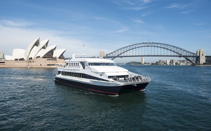 Sydney Harbour cruise boat with Opera House and Harbour Bridge in background.
