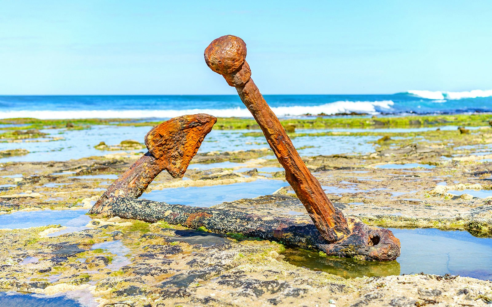 Rusty anchor on Shipwreck Coast shoreline.