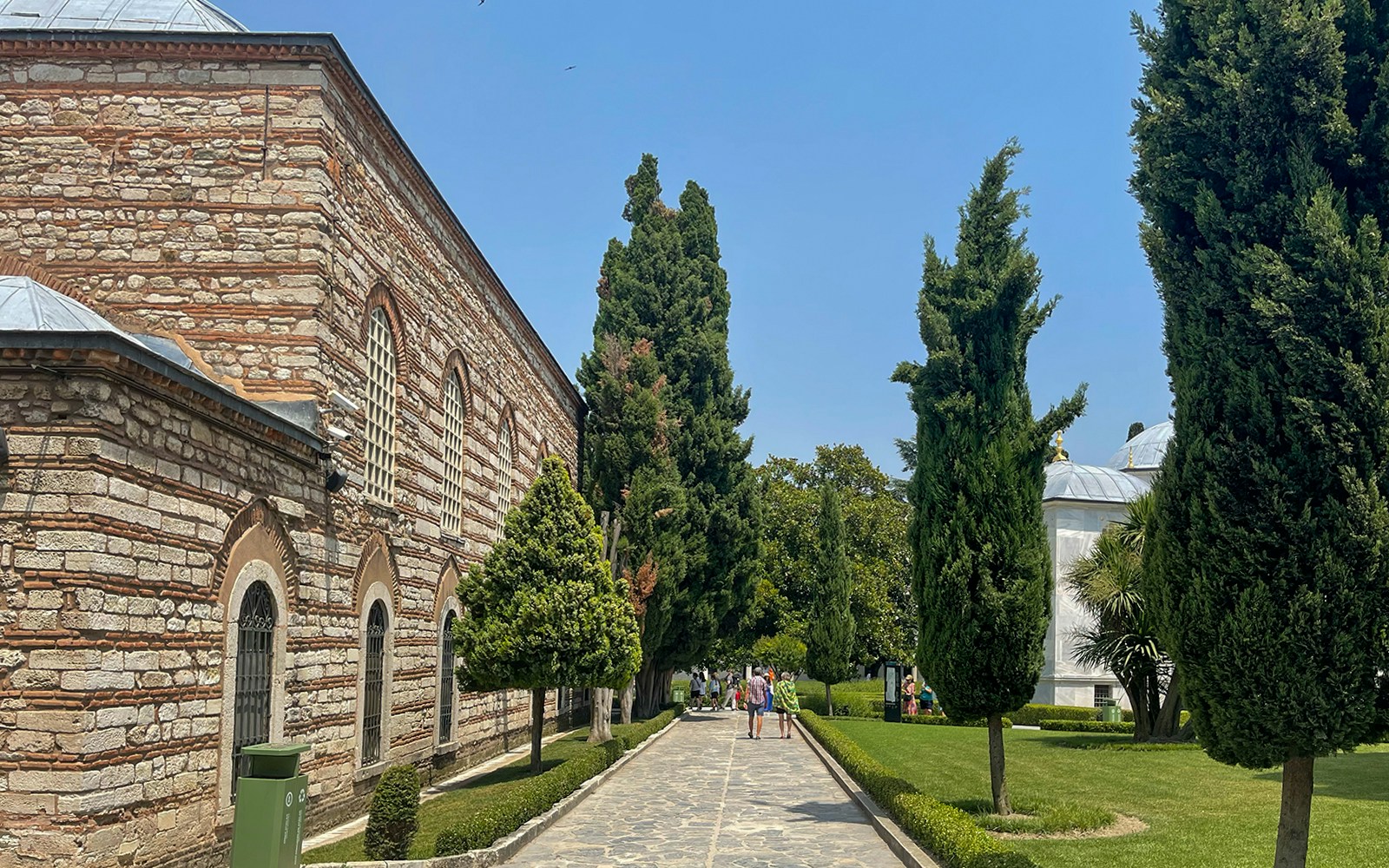Pathway and gardens at Topkapi Palace, Istanbul, with visitors walking.