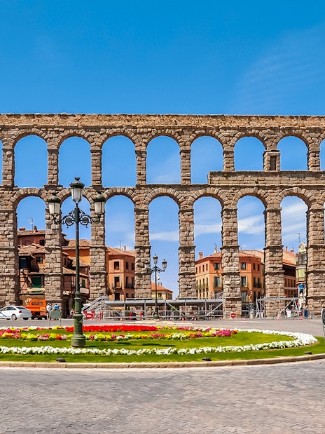 Aqueduct of Segovia with arches and cityscape in the background, Segovia, Spain.