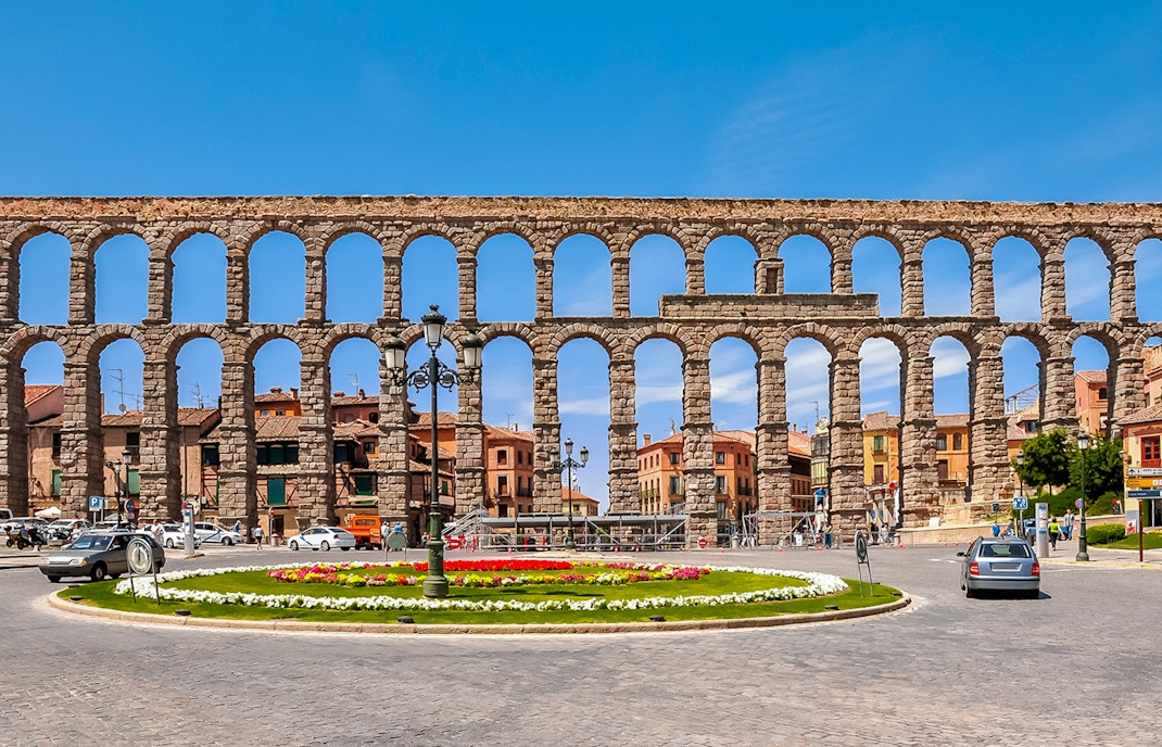 Aqueduct of Segovia with arches and cityscape in the background, Segovia, Spain.