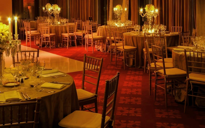 Elegant dining setup at Rojo Tango Show venue with candlelit tables.