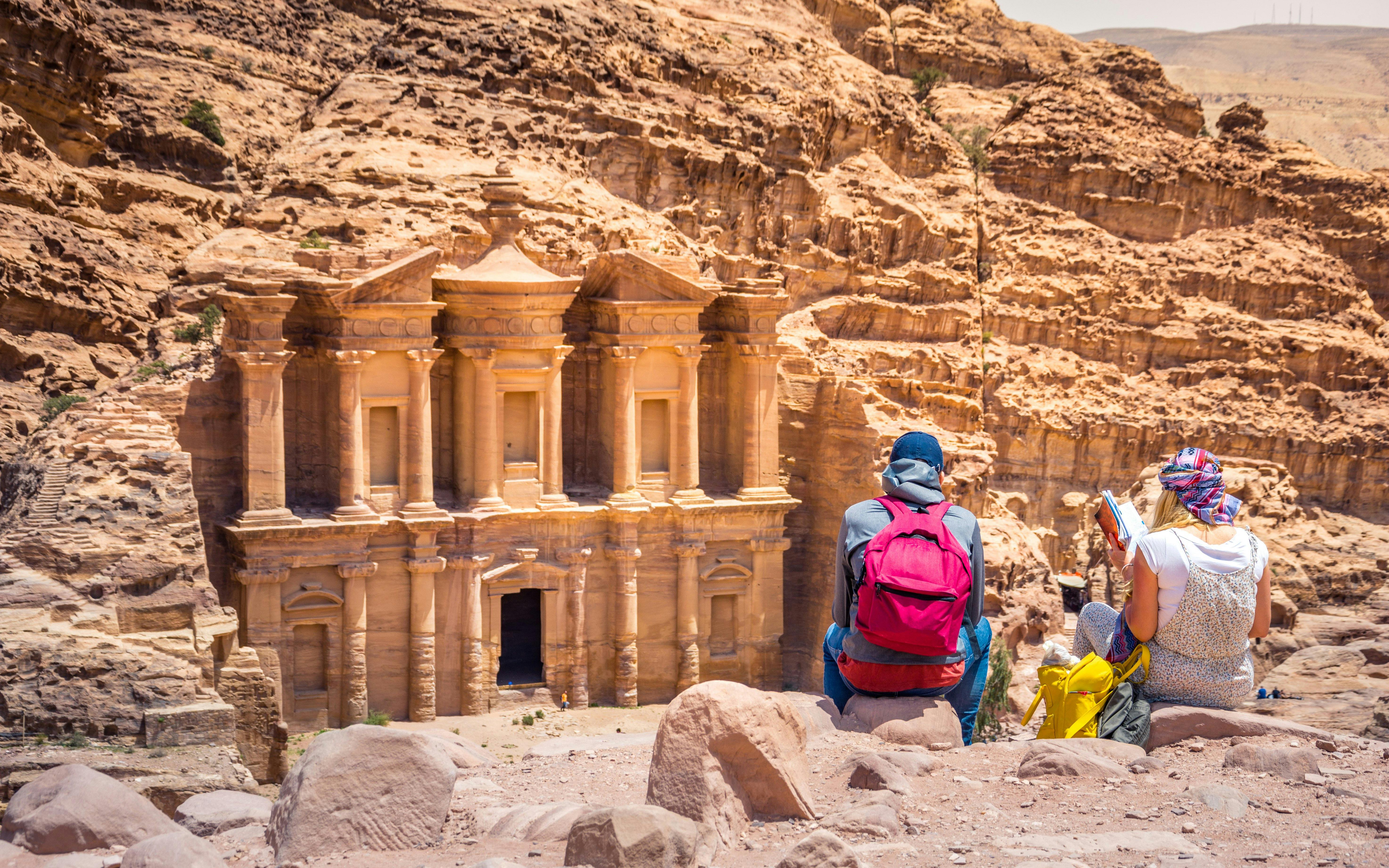Tourists viewing the Monastery at Petra, Jordan.