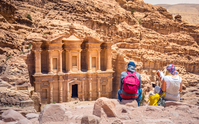 Tourists viewing the Monastery at Petra, Jordan.