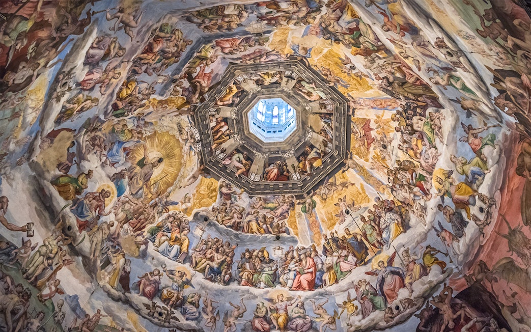 Frescoes inside Florence Duomo's dome, depicting religious scenes, viewed during the Express Guided Tour.