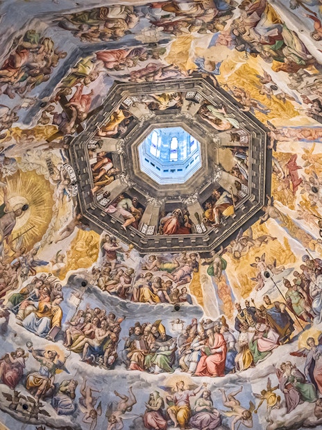 Frescoes inside Florence Duomo's dome, depicting religious scenes, viewed during the Express Guided Tour.