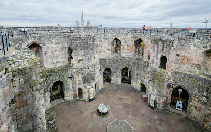 Clifford's Tower interior with stone walls and arched openings in York, England.