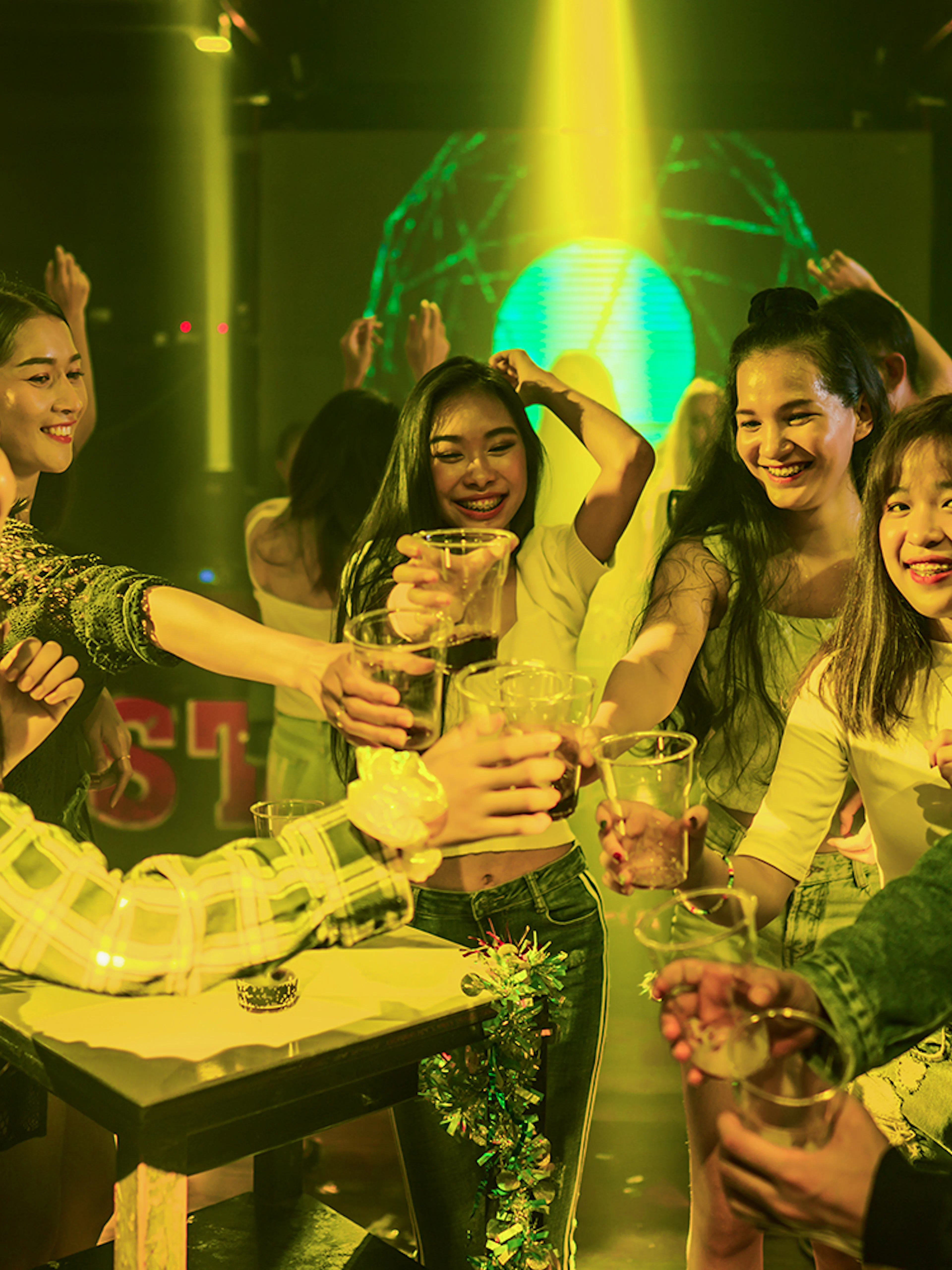 Group enjoying drinks during Singapore pub crawl event.
