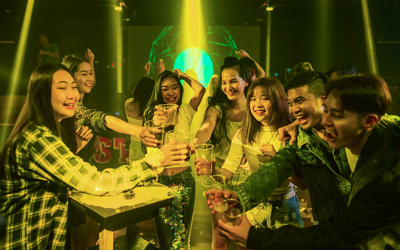 Group enjoying drinks during Singapore pub crawl event.
