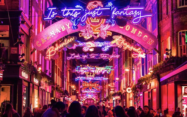 Carnaby Street illuminated with vibrant Christmas lights in London.