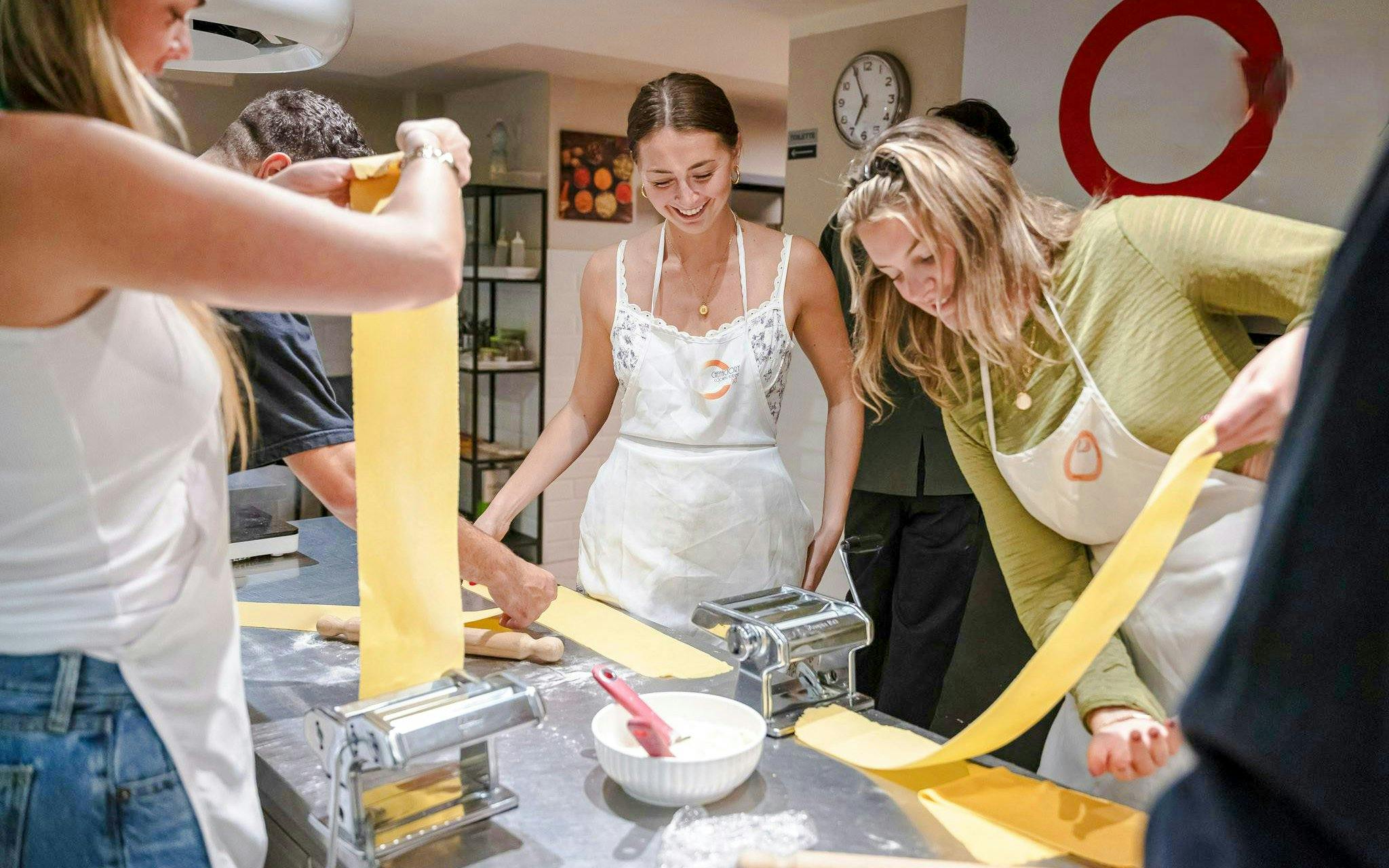 Participants making pasta in a Florence cooking class.