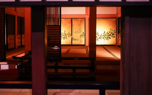 Traditional Japanese room interior at Kumamoto Castle, featuring tatami mats and decorative screens.