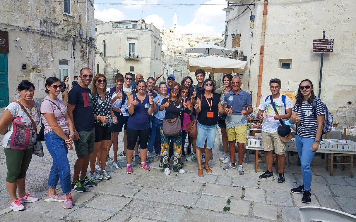 Group of tourists in Sassi of Matera during 45-min tour with guide.