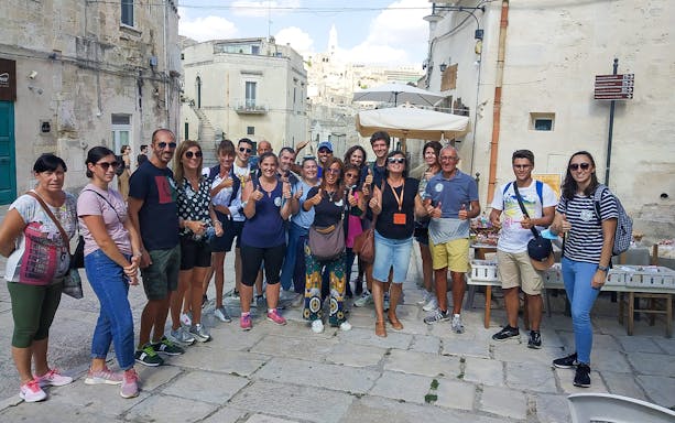 Group of tourists in Sassi of Matera during 45-min tour with guide.