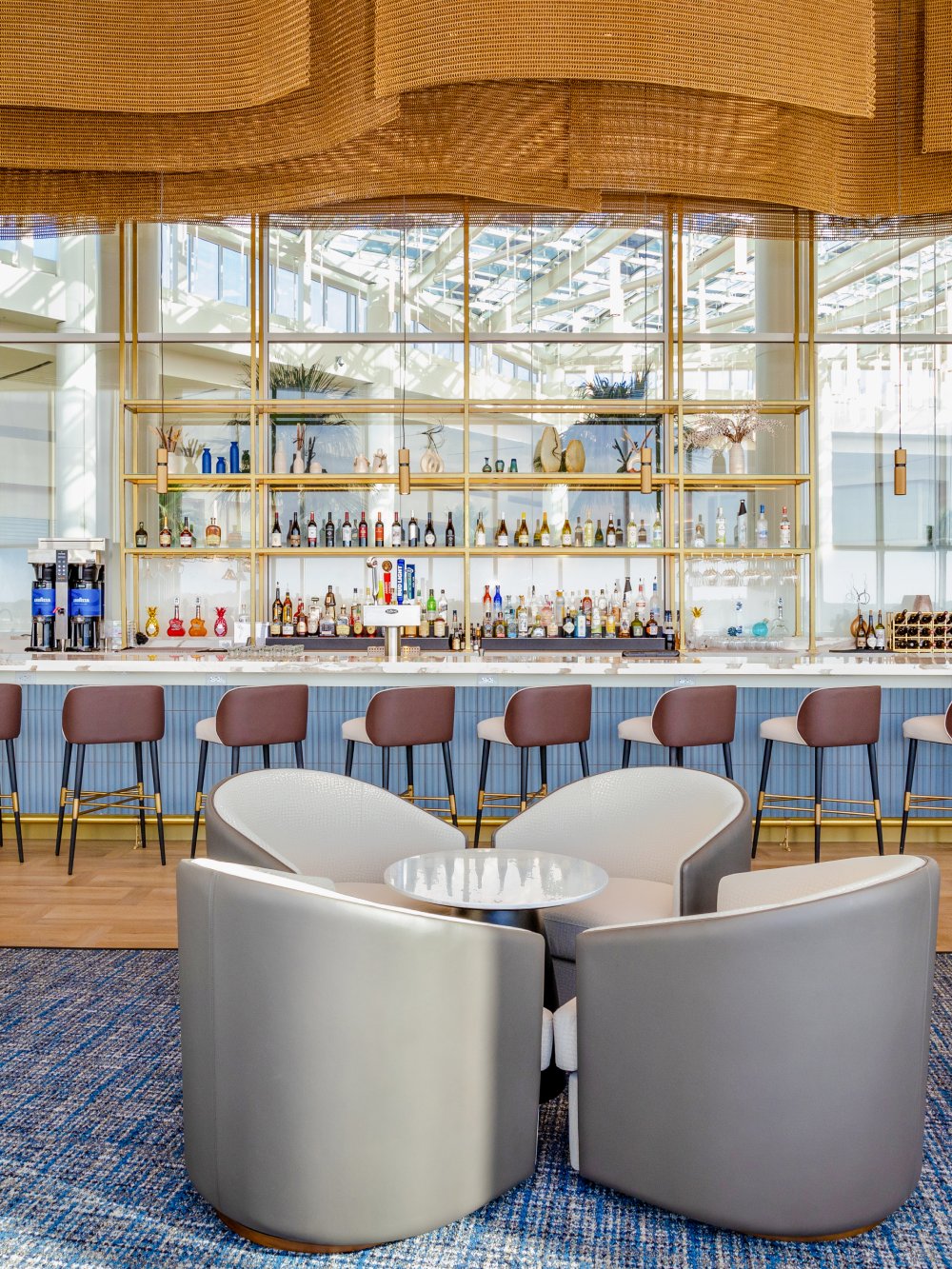 Bar seating and modern decor at Plaza Premium Lounge, Orlando Airport Terminal C.