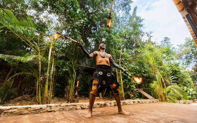 Performer juggling fire at Cancun Extreme Adventuring Park.