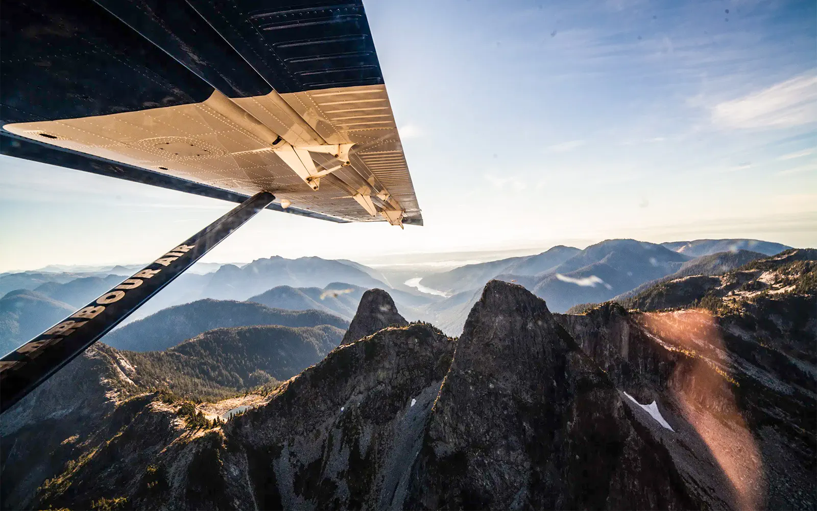 Seaplane wing over Whistler Glacier with mountain views on sightseeing tour.