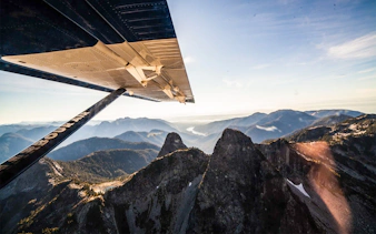Seaplane wing over Whistler Glacier with mountain views on sightseeing tour.