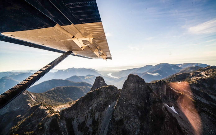 Seaplane wing over Whistler Glacier with mountain views on sightseeing tour.