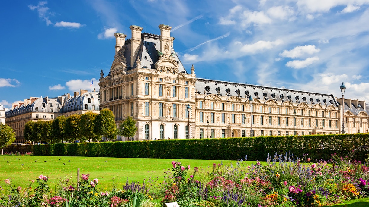 Louvre Museum exterior with gardens in Paris, France.