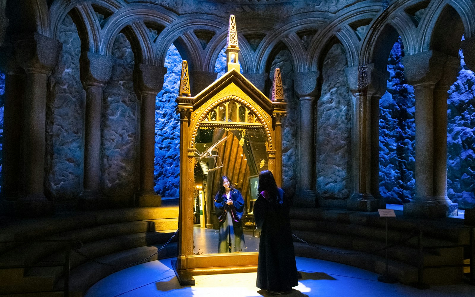 Person in wizard robe looking into the Mirror of Erised at Warner Bros. Studio Tour Tokyo.