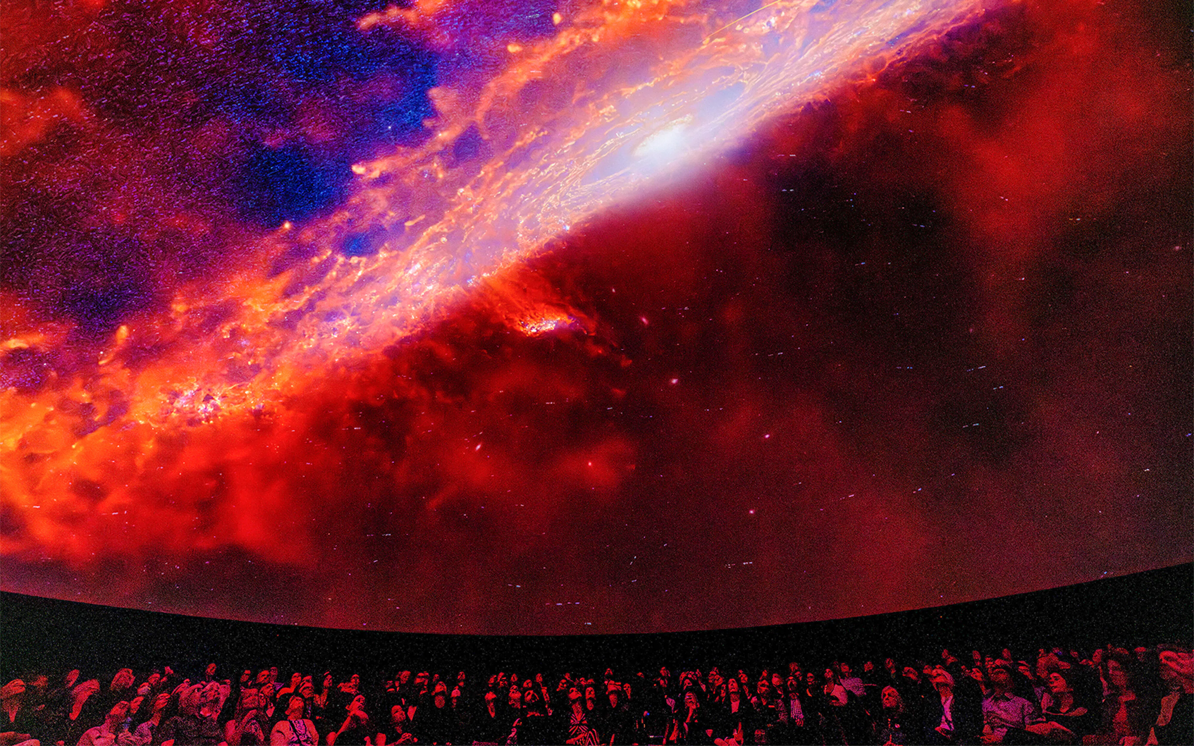 Visitors viewing galaxy projection at Encounters in the Milky Way exhibit, American Museum of Natural History.