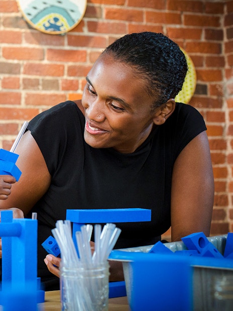 Child engaging in a building activity at Boston Children's Museum.