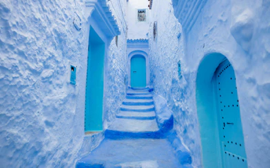 Narrow blue alleyway with steps in Chefchaouen, Morocco.