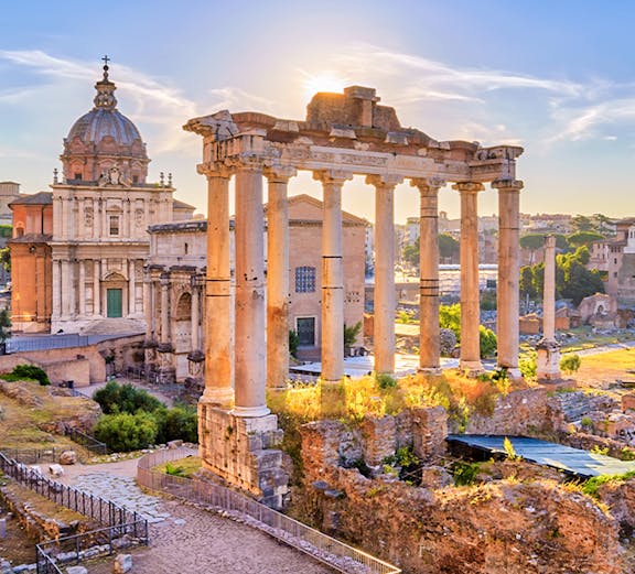 Roman Forum ruins with ancient columns and historic architecture in Rome, Italy.