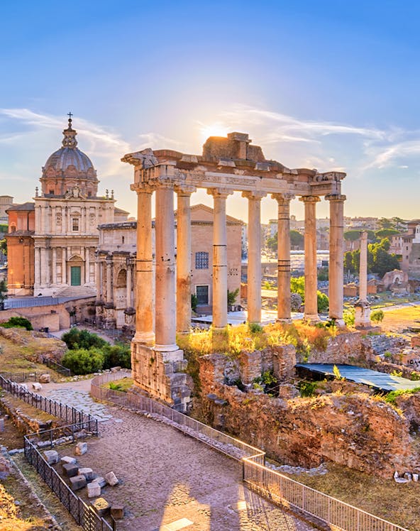 Roman Forum ruins with ancient columns and historic architecture in Rome, Italy.