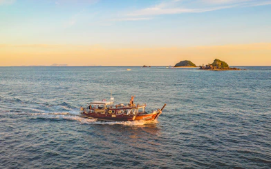 Luxury longtail boat cruise at sunset near Krabi with people on board.