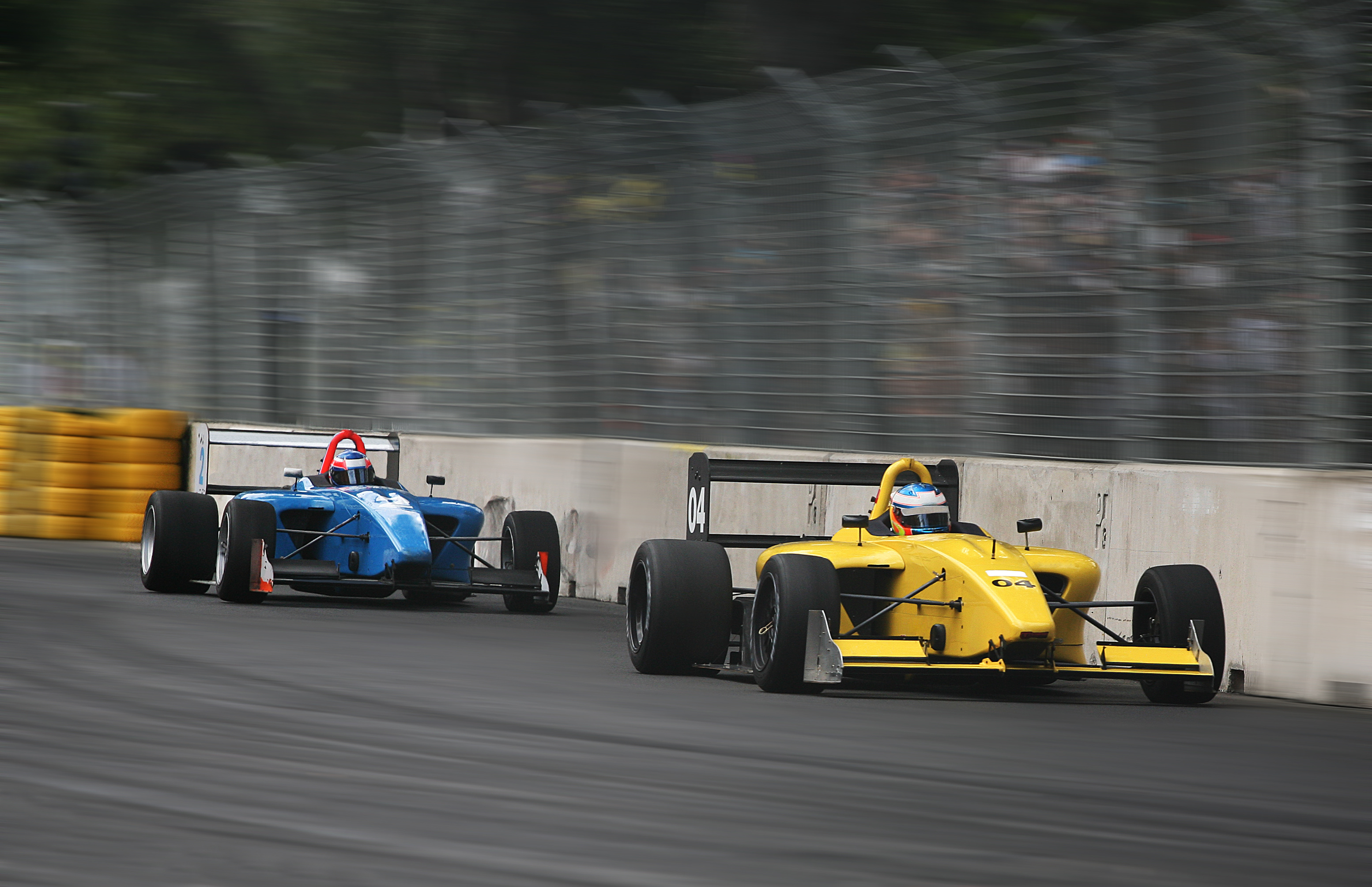 Two race cars on a track during a grand prix event.