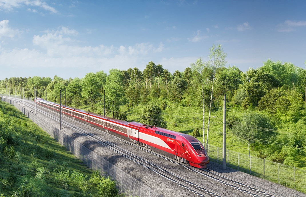 Eurostar train traveling through lush green countryside in Europe.