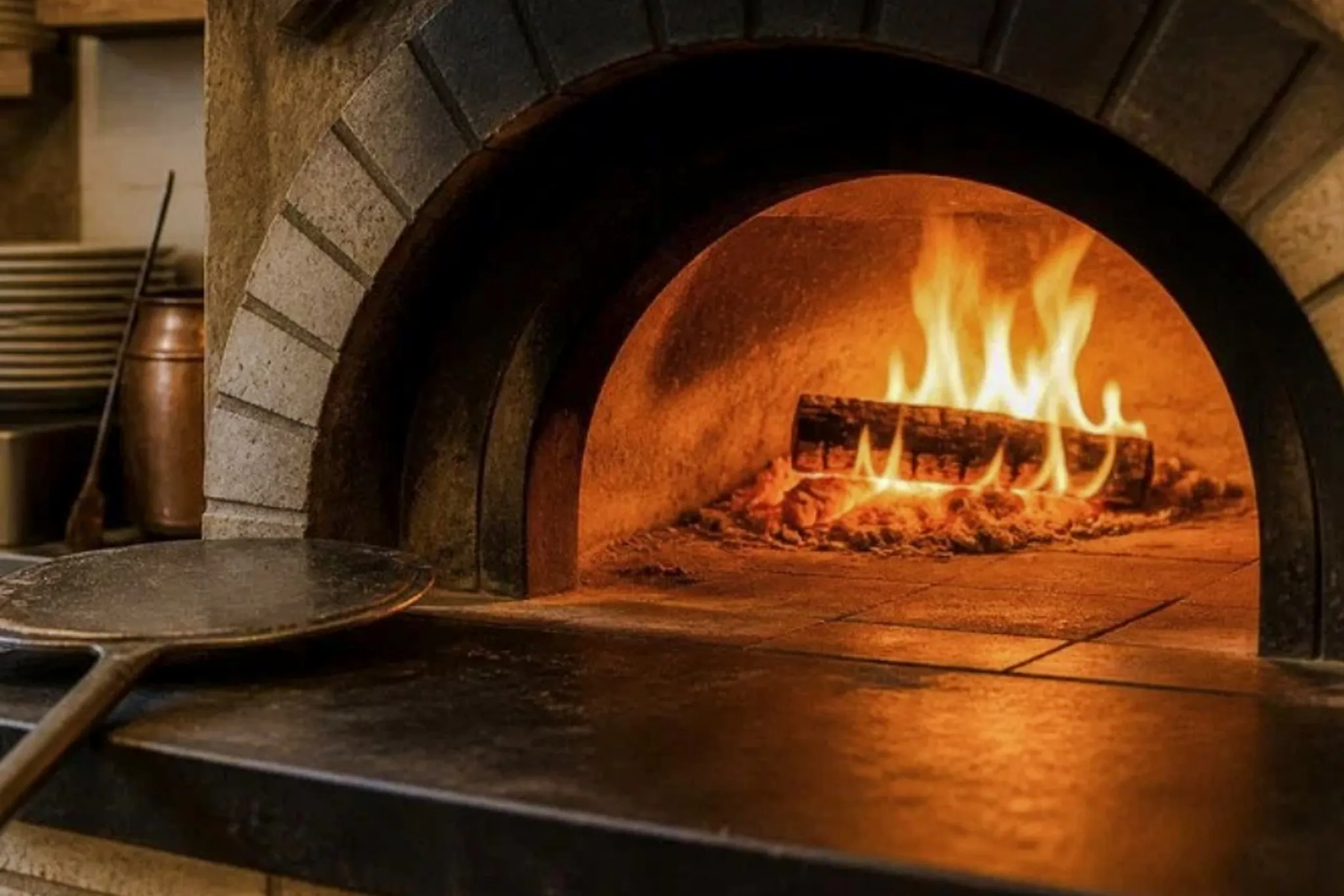 Wood-fired oven with flames for pasta class in Florence, Italy.