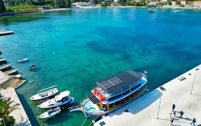 Boat docked at Dubrovnik harbor for Elaphite Islands tour with open bar and lunch.