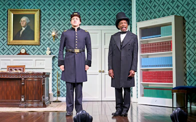 Actors in period costumes on stage in a West End theater production of "Oh Mary.
