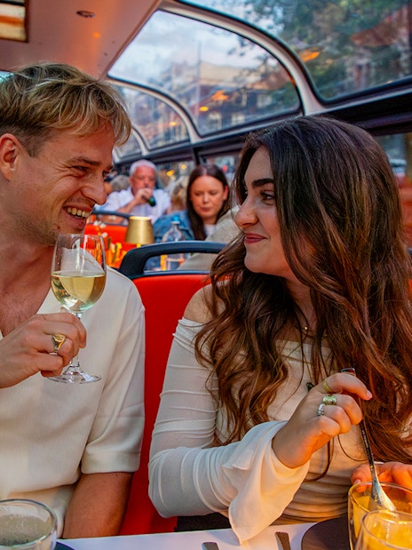 Guests enjoying wine on a scenic dinner cruise.