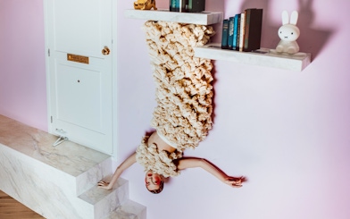 Visitors in Dutch Design Room at Upside Down Amsterdam with upside-down decor.