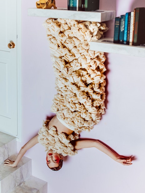 Visitors in Dutch Design Room at Upside Down Amsterdam with upside-down decor.