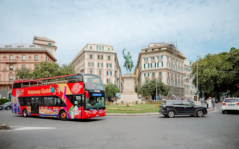 City Sightseeing bus near a statue in Genova, Italy.